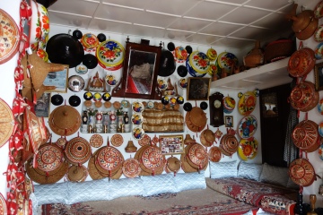My guesthouse's lunge room was decorated in the traditional Harari style. Lounge rooms in many homes in the jugol share this layout and style. The different elevations of the seats denote seniority within the Harari social hierarchy. The highest seat, towards the back, is reserved for male religious leaders and scholars. The lowest seats are reserved for women.