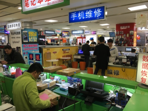 People make and repair phones and tablets at the Gangding Computer Markets.