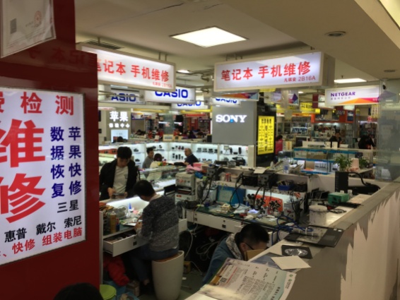 People make and repair phones and tablets at the Gangding Computer Markets.